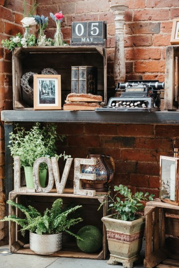 Entrance table styling at shustoke farm barns - prop hire - crates - wild herbs - love letters