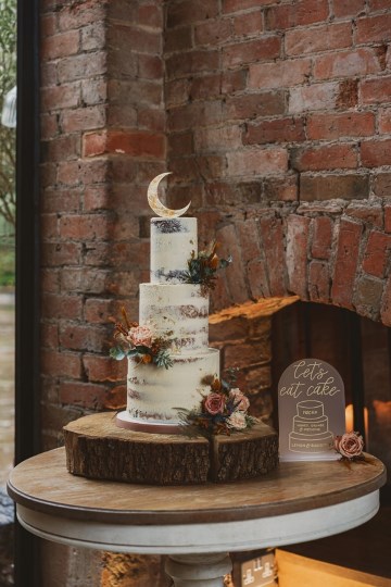semi naked cake with added floral sprays to match theme wedding at shustoke farm barns 