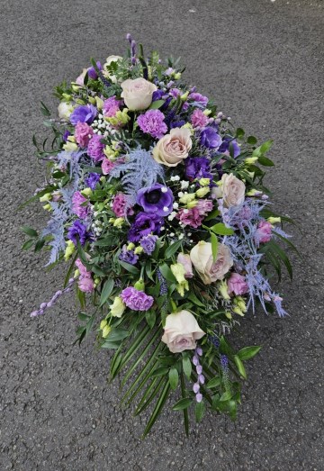 purple and lilac casket spray funeral tribute