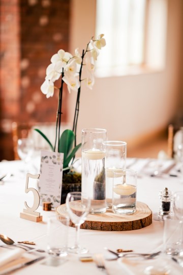 ivory and white wedding flowers - ivory avalanche roses - lisianthus - hydrangea - bridal bouquet - wedding at Wooten Park Wedding Venue - phalaenopsis orchid table displays 