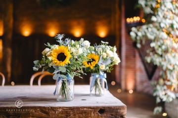 yellow and blue theme wedding at shustoke farm barns - yellow and blue flowers - yellow roses - blue delphiniums - sunflowers - blue thistle - buttonholes - bridesmaids bouquets