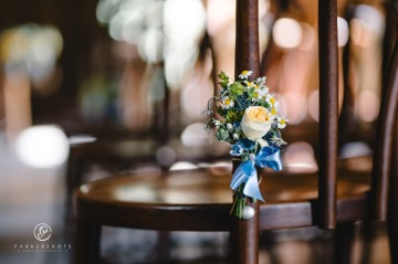 yellow and blue theme wedding at shustoke farm barns - yellow and blue flowers - yellow roses - blue delphiniums - sunflowers - blue thistle - buttonholes - bridesmaids bouquets- chair decorations 