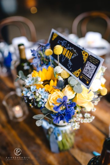 yellow and blue theme wedding at shustoke farm barns - yellow and blue flowers - yellow roses - blue delphiniums - sunflowers - blue thistle - buttonholes - bridesmaids bouquets