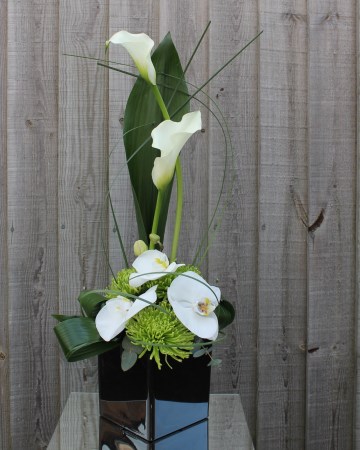 Black Cub Vase Display Calla Lily, Phalaenopsis And Chrysanthemum Blooms 