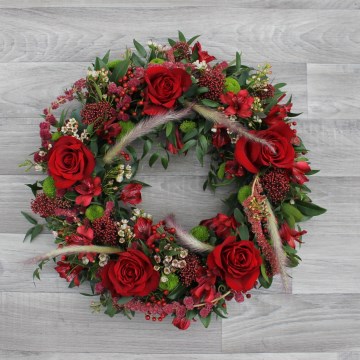mixed wreath featuring red rose, hypericum, alstromeria green santin iand mixed foliages 