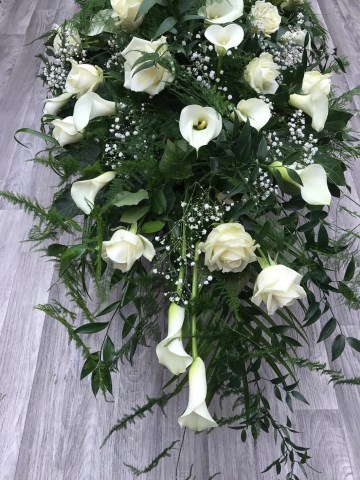 white Rose and Calla Lilly casket spray with soft trailing fern 