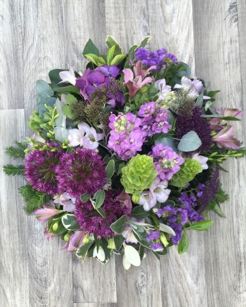 lilac and purple posy display - funeral tribute design - lilac rose - purple lisianthus - allium - freesia