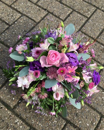 pink and purple posy display - funeral tribute design - pink roses - purple lisianthus - freesia 