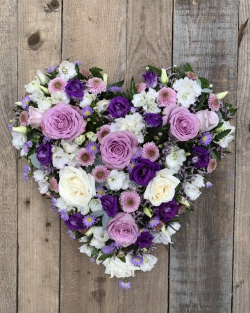 full heart featuring lilac and blush roses with lilac and purple lisianthus
