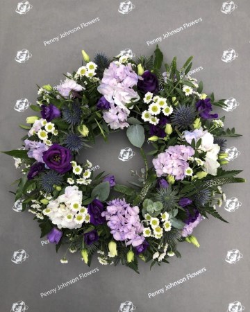 lilac, purple and white mixed wreath featuring hydrangea, lisianthus, veronica and santini 