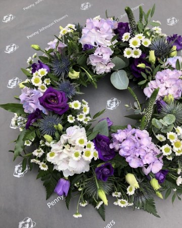 lilac, purple and white mixed wreath featuring hydrangea, lisianthus, veronica and santini