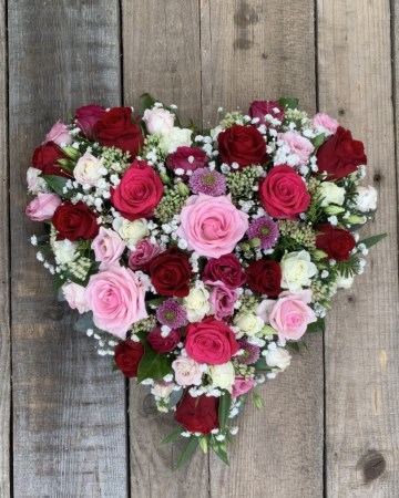 full heart of mixed pink red and ivory roses 