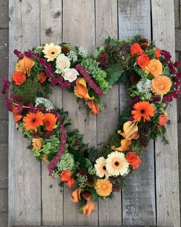 contemporary open heart- mixed oranges, peach and green flowers