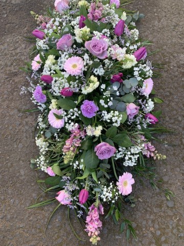 Casket spray of lilac and purple flowers