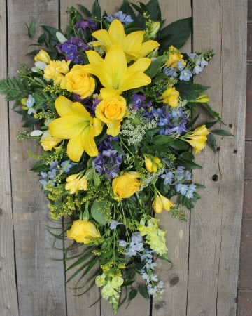 lemon and blue single ended spray - yellow rose and lily with blue delphiniums and purple lisanthus 