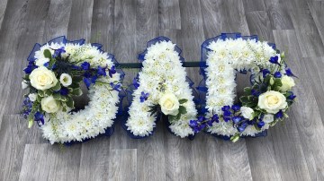 DAD funeral tribute based in white chrysanth with royal ble ribbon edge and blue and white sprays 