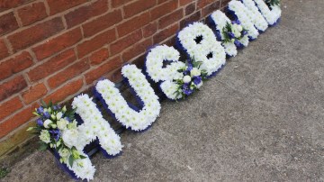funeral tribute letters - husband based in white chrysanthemum with royal blue ribbon edge and blue and white sprays 