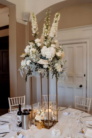 Table Centrepiece on gold stand - ivory and white floral displays featuring Hydrangea, Avalanche Rose, Anthuriums, Peony and Gypsophila - at Moxhull Hall wedding Venue