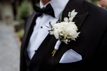 grooms buttonhole - ivory and white flowers - peony with dried bleached ruscus 